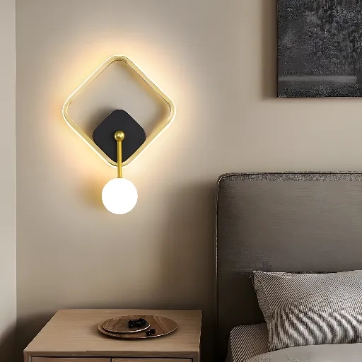Gold LED wall sconce beside a bed - Elmadinah
